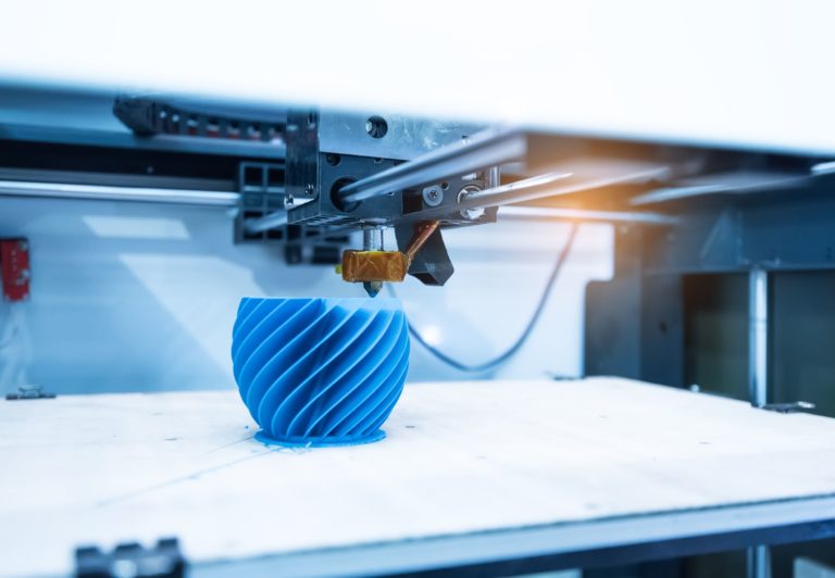 Modern 3D printer printing figure close-up macro